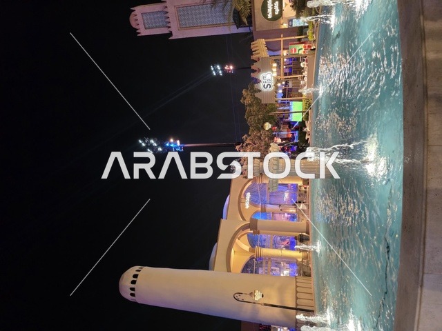The water lake in Boulevard World in Riyadh, the architectural engineering art in a modern style, enjoying fun experiences in the most prominent entertainment areas in the Kingdom of Saudi Arabia, attractions that draw and attract tourists from around the world.