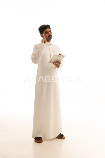 Saudi Man in Thobe Thinking with Notepad on White Background