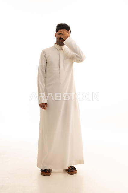 Saudi Man in Thobe Covering Face on White Background