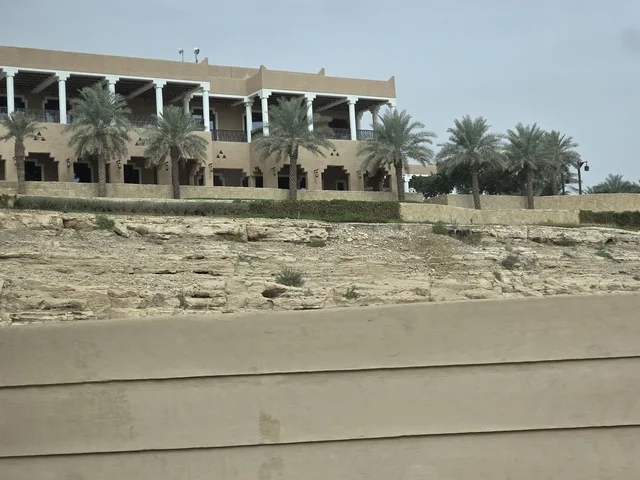 The old walls of Diriyah in the city of Riyadh, Saudi Arabia, are ancient historical archaeological landmarks, showcasing ancient architectural engineering art. A picture of the archaeological buildings and mud houses in the Al-Turaif neighborhood in Diriyah, with green palm trees, represents the heritage tourism areas in Saudi Arabia.