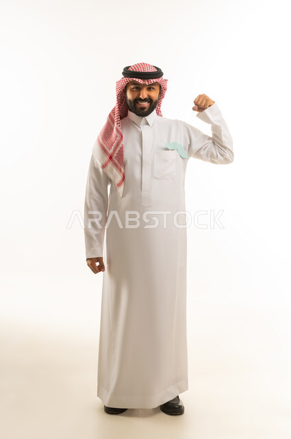 Saudi Man in Traditional Dress Flexing Arm for Strength