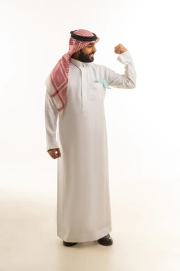 رجل سعودي بالثوب التقليدي يستعرض عضلات ذراعه