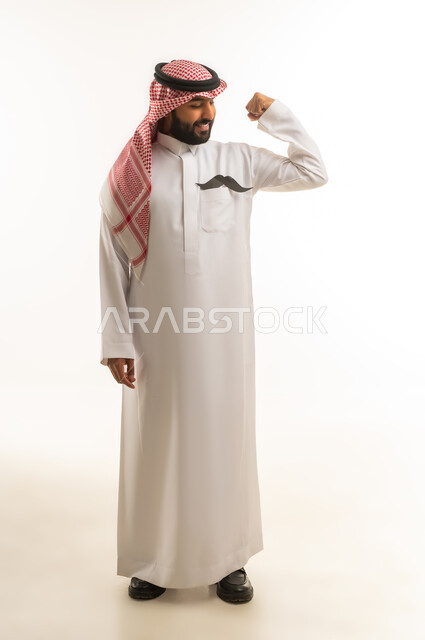 Saudi Man in Traditional Thobe Flexing Muscles
