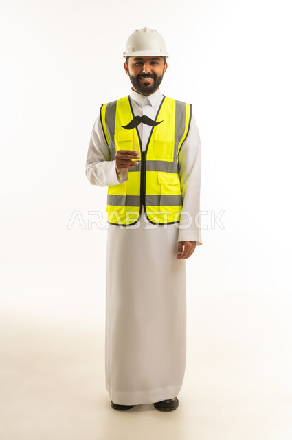 Saudi Engineer in Safety Vest Holding Mustache Prop
