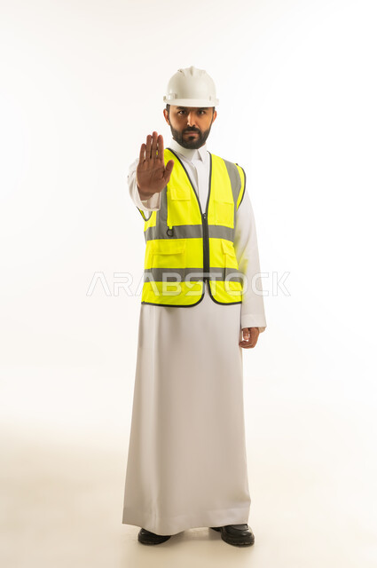 Saudi Engineer in Safety Gear with Stop Gesture