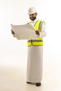 مهندس سعودي بالثوب يمسك مخططات هندسية في الاستوديو