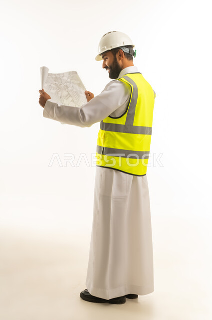 Saudi Male Engineer Holding Construction Blueprint