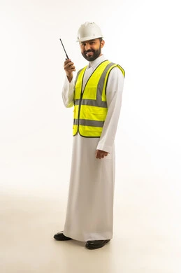 Saudi Engineer in Thobe and Safety Gear with Radio