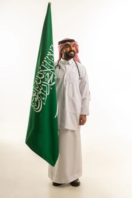 Saudi Male Doctor Holding National Flag on White Background