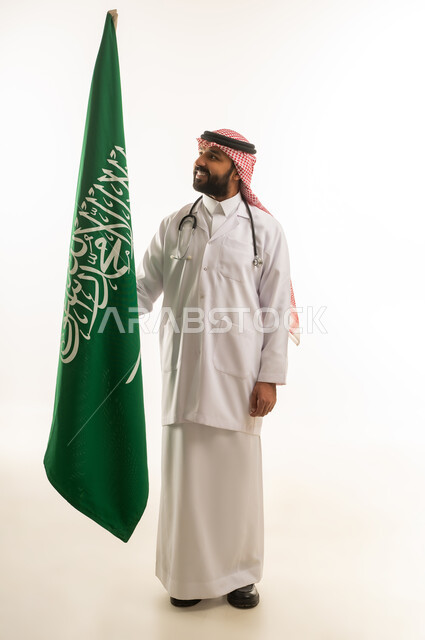 Saudi Male Doctor in Traditional Dress with Saudi Flag