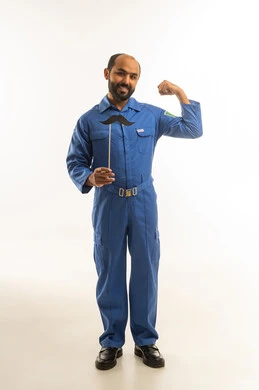 Saudi Technician in Blue Uniform Flexing Muscle
