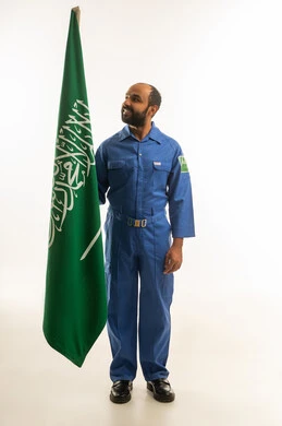 Saudi Worker in Blue Uniform with National Flag