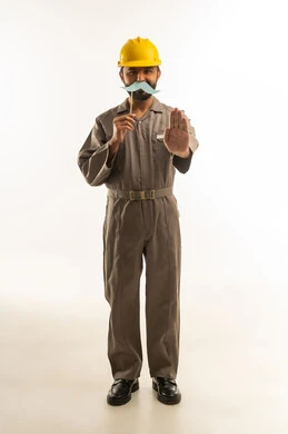 Saudi Engineer in Grey Jumpsuit with Stop Gesture