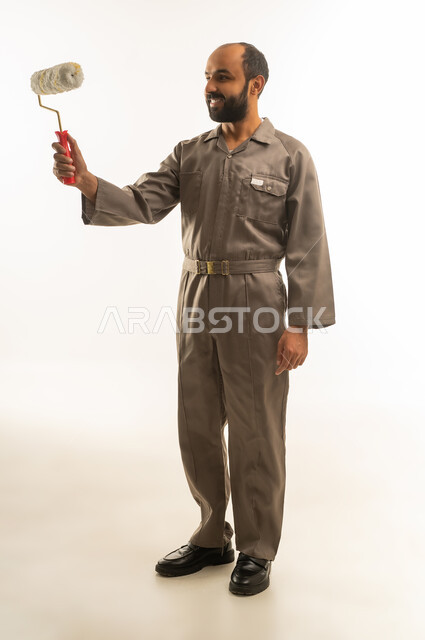Saudi Man in Work Jumpsuit Holding Paint Roller