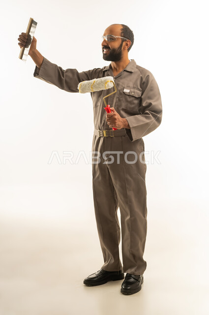 Saudi Painter in Brown Uniform Holding Tools