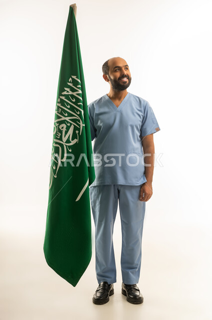Saudi Male Doctor in Blue Scrubs with Saudi Flag
