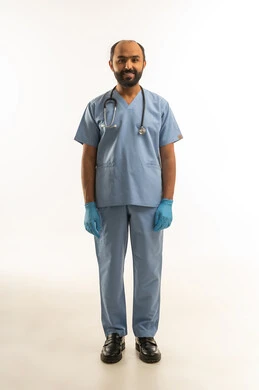 طبيب سعودي بزي العمليات الأزرق على خلفية بيضاء