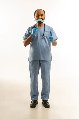 Saudi Male Doctor in Blue Scrubs Holding Mustache Prop Saudi Male Doctor in Blue Scrubs Holding Mustache Prop