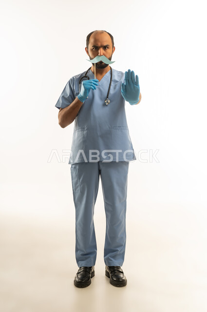 Middle Eastern Male Doctor in Blue Scrubs Stop Gesture