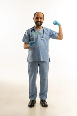 Arab Doctor in Blue Scrubs Holding Mustache Prop