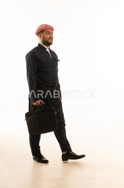 Kurdish Man in Traditional Attire Walking with Laptop Bag
