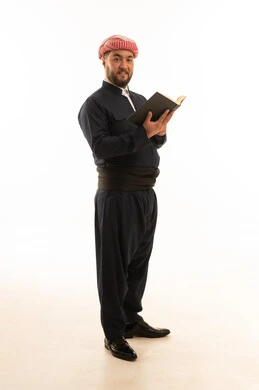 Kurdish Man in Traditional Black Outfit Holding Book