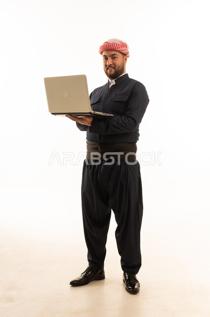 Kurdish Man in Traditional Dress Holding Laptop