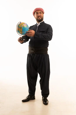 رجل بالزي الكوردستاني التقليدي يحمل الكرة الأرضية