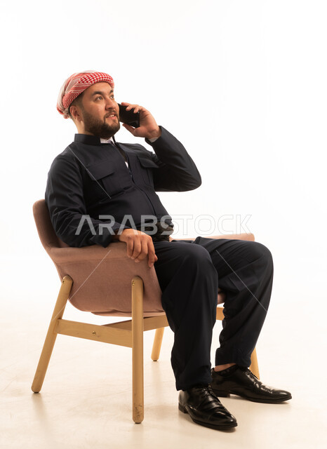 Kurdish Man in Traditional Black Attire on Phone