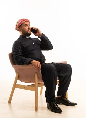 Kurdish Man in Traditional Black Attire on Phone
