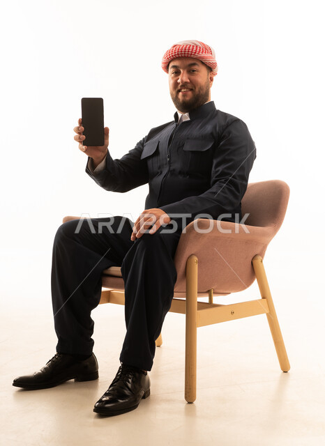 Kurdish Man in Traditional Clothing Holding Smartphone