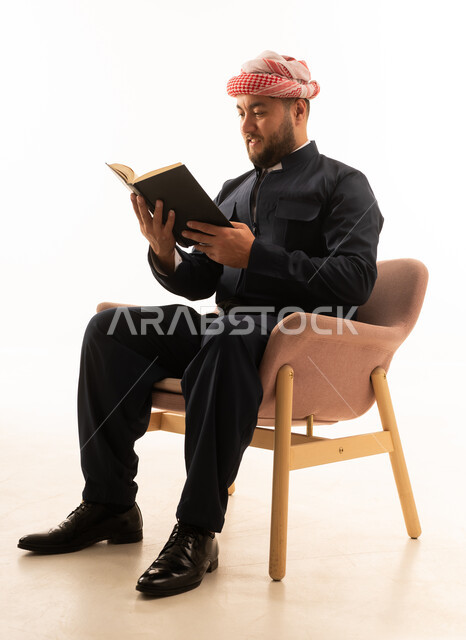 Kurdish Man in Traditional Attire Reading Book