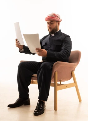 Kurdish Man in Traditional Black Outfit Reading Documents