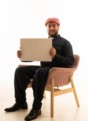 Man in Traditional Clothing Holding Blank Sign