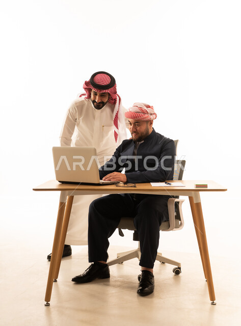 Saudi and Kurdish Businessmen Working on Laptop