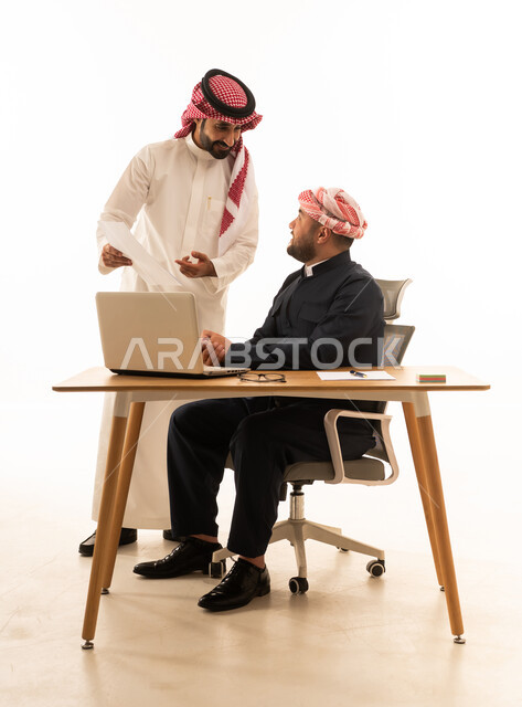 Saudi and Kurdish Men Discussing Business at Desk