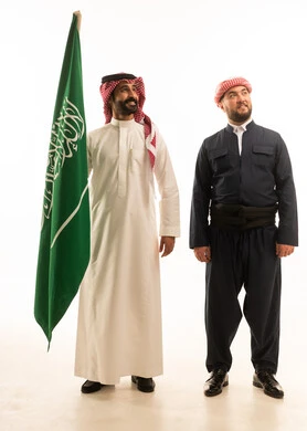 Saudi and Kurdish Men in Traditional Attire with Flag