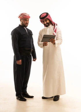 Saudi and Kurdish Men Using Tablet on White Background