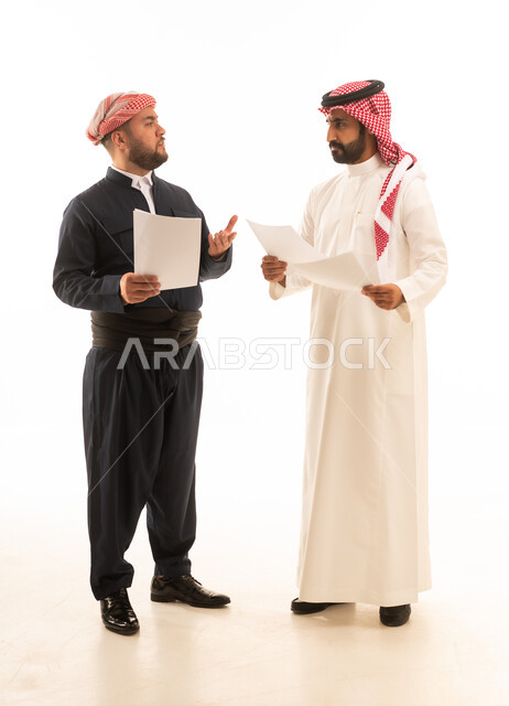 Saudi and Kurdish Men Discussing Business Papers