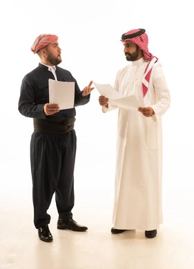 Saudi and Kurdish Men Discussing Documents on White