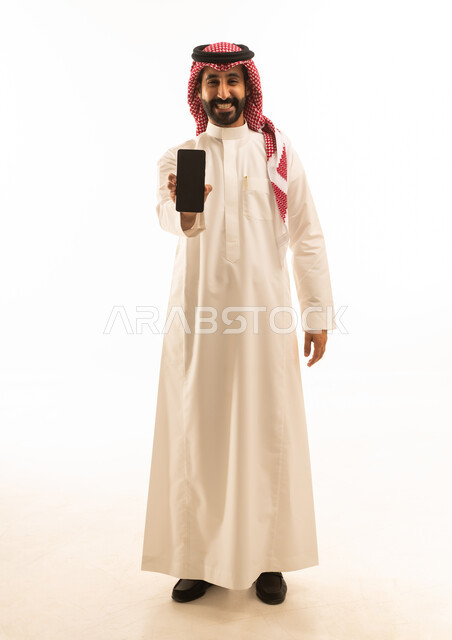 Saudi Man in Thobe Holding Smartphone on White Background