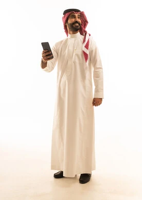 Saudi Man in Thobe Using Smartphone on White Background