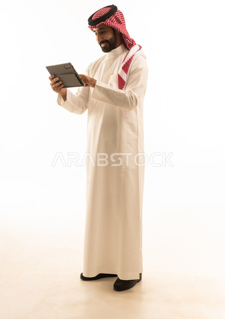 Saudi Man Using Digital Tablet on White Background