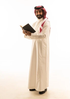 Saudi Man in Traditional Thobe Holding Book