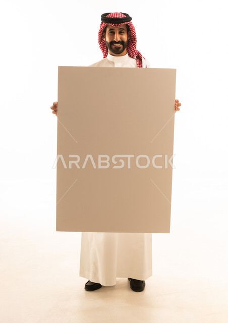 Saudi Man in Traditional Thobe Holding Blank Board