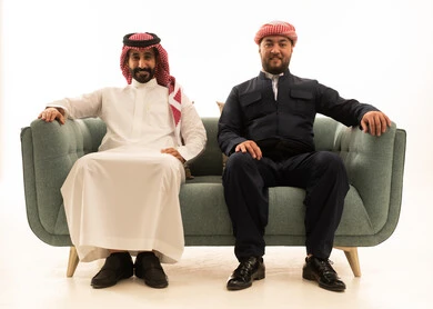 Saudi and Kurdish Men in Traditional Attire on Sofa