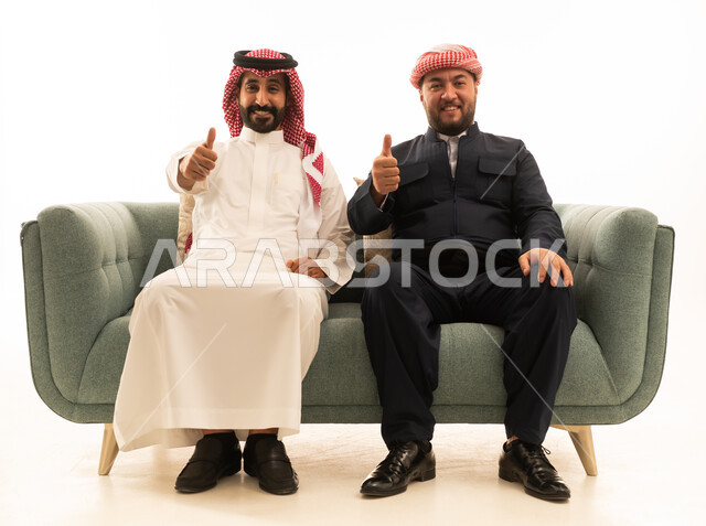 Saudi and Kurdish Men Giving Thumbs Up on Sofa