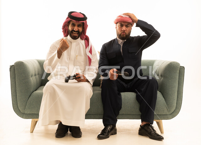 Saudi and Kurdish Men Gaming on Sofa White Background