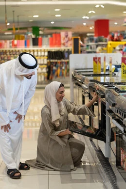 Emirati Couple Shopping for Home Appliances in Store