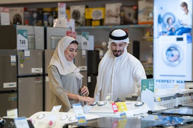 Emirati Couple Shopping for Appliances in Electronics Store